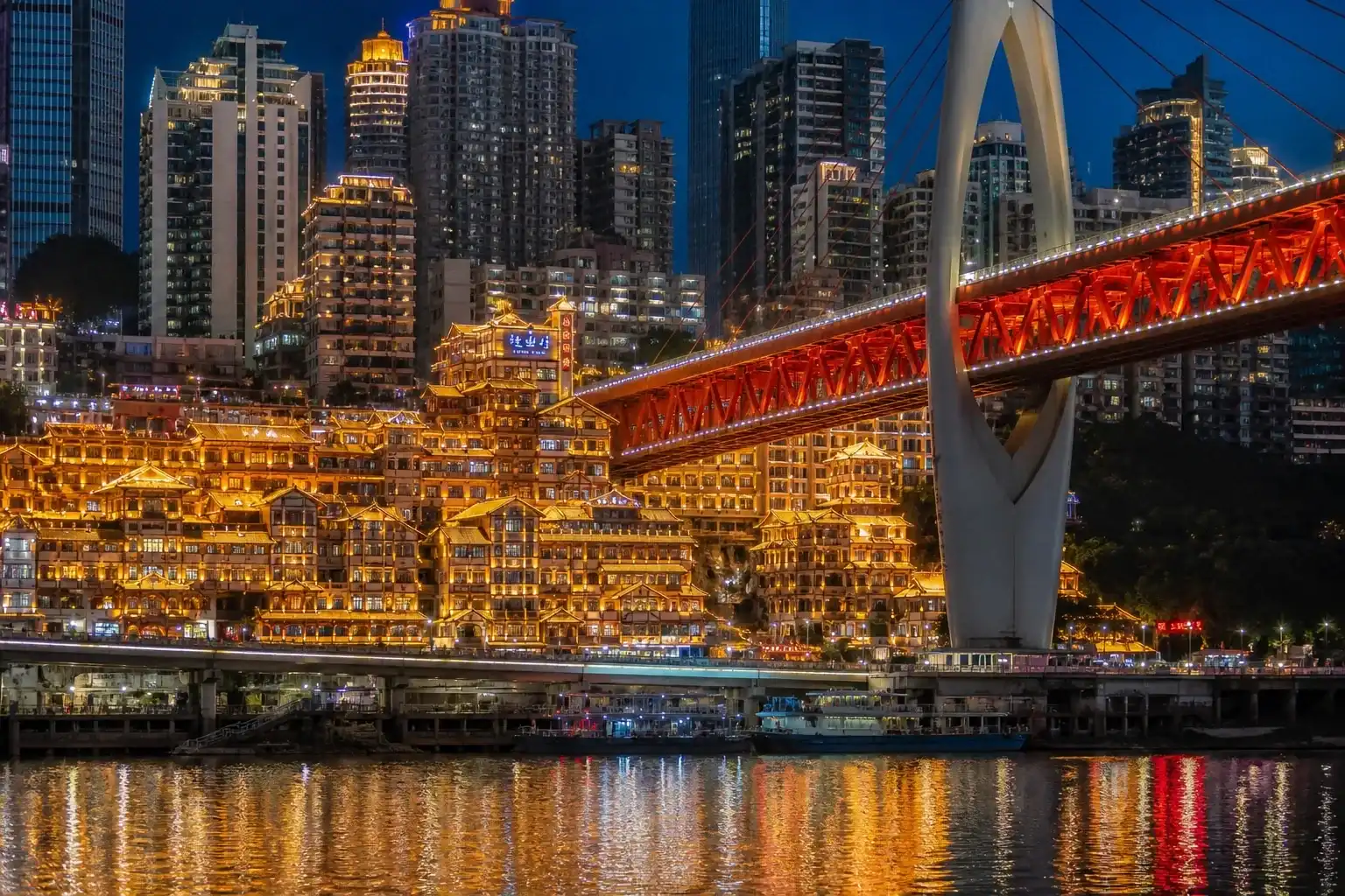 Hongya Cave and Qiansimen Bridge illuminated beside the Jialing River in Chongqing