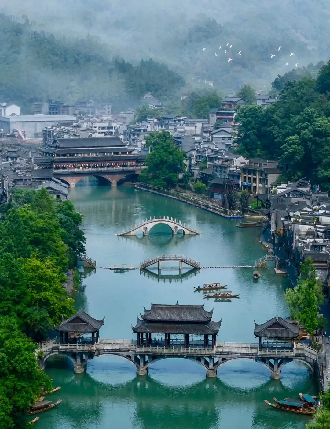 The Tuo River, bridges and riverside stilt houses in Fenghuang at night