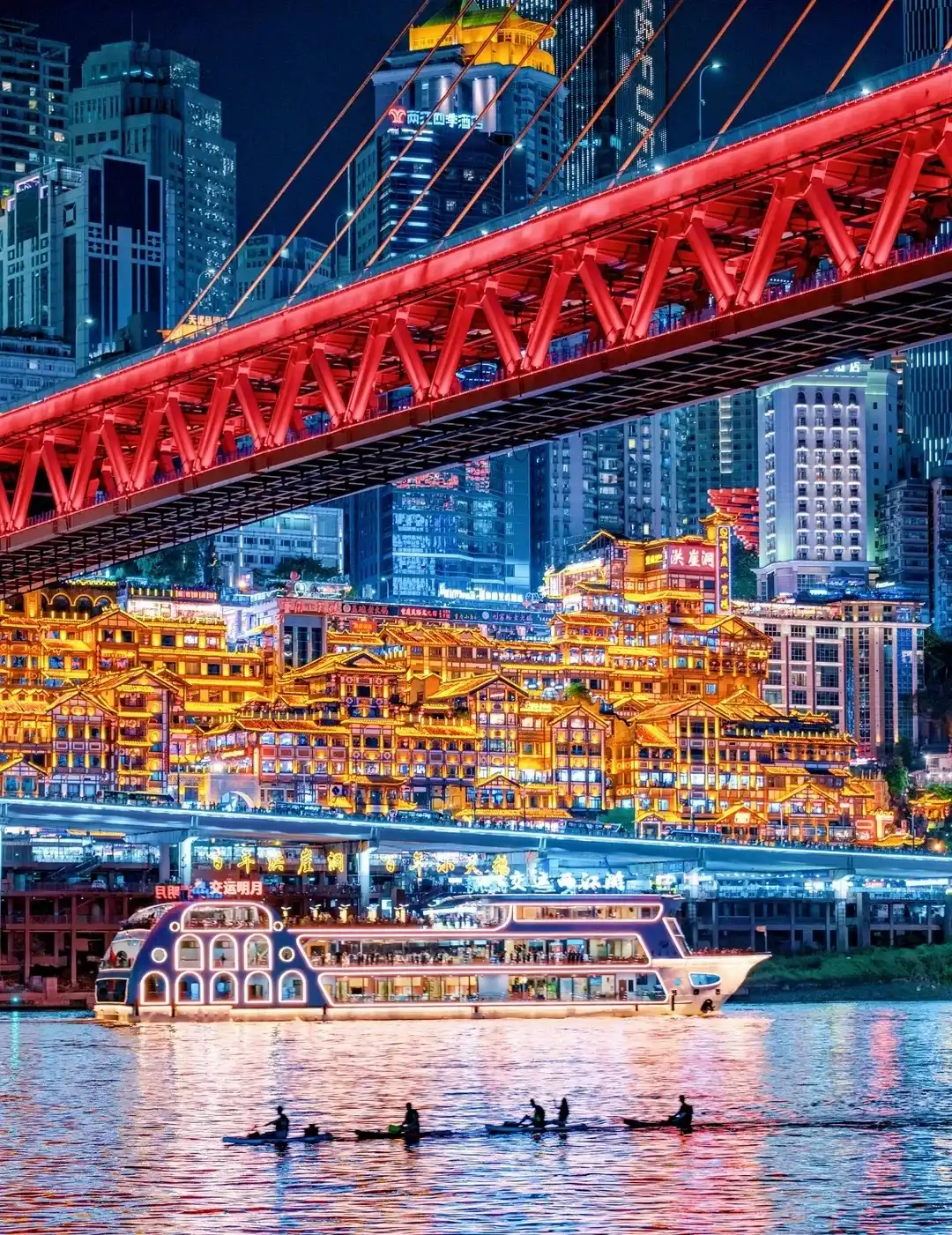 Qiansimen Bridge crossing above illuminated Hongya Cave beside the Jialing River