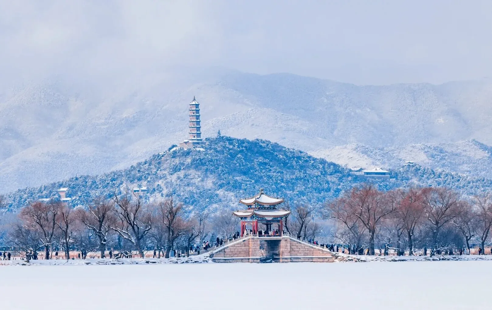 Snowy shore, pavilion and distant hills