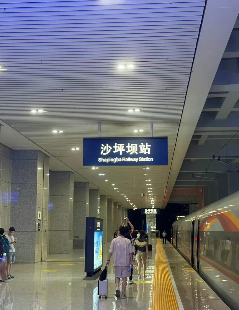 Train and Shapingba station signs on an underground national-rail platform