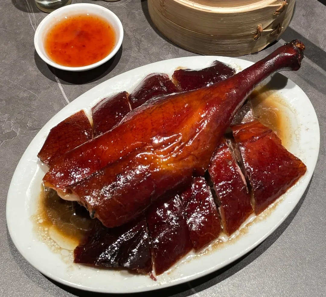 Bone-in pieces of Gongming roast goose arranged with a whole leg